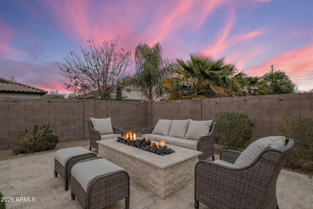 view of patio / terrace featuring an outdoor living space with a fire pit and a fenced backyard