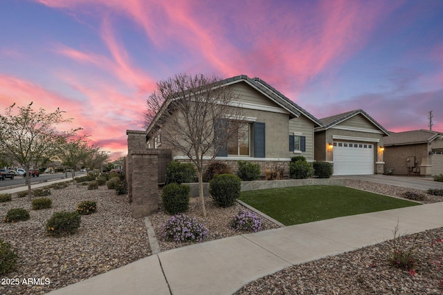 view of front of house featuring a garage, concrete driveway, and a front lawn