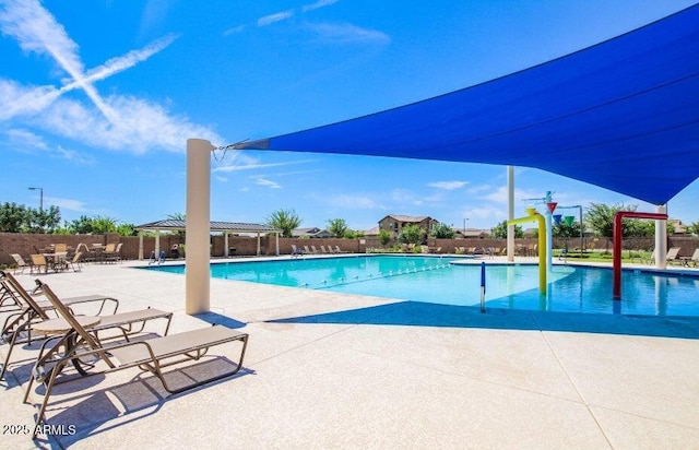 community pool featuring fence, a pergola, and a patio