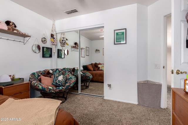 bedroom featuring a closet, visible vents, and carpet