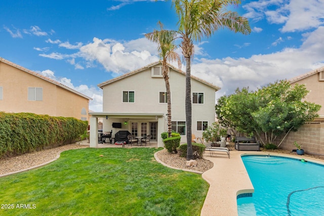 rear view of house featuring stucco siding, a patio, a fenced backyard, a fenced in pool, and a lawn