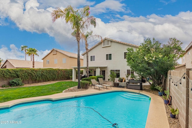 view of swimming pool with a fenced backyard, a fenced in pool, and a patio area