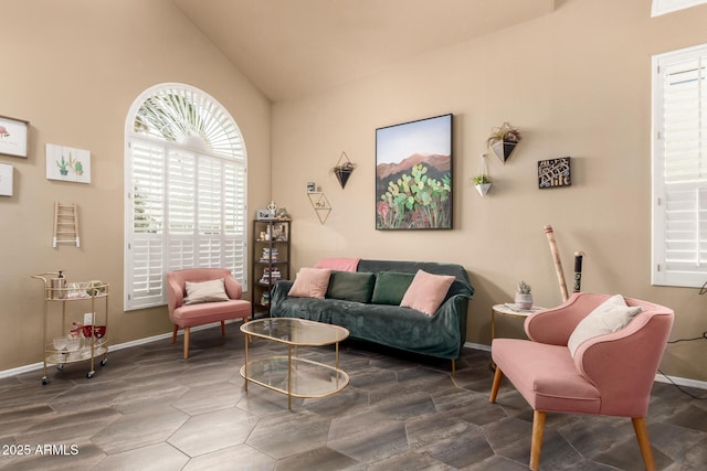 living room with baseboards and vaulted ceiling