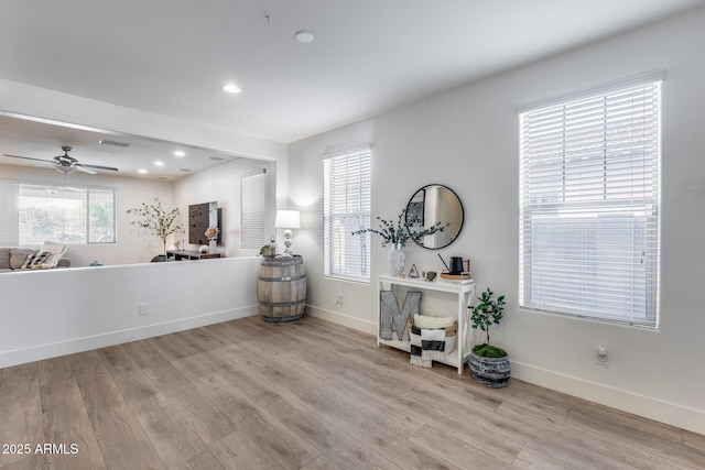 interior space with ceiling fan and light hardwood / wood-style floors