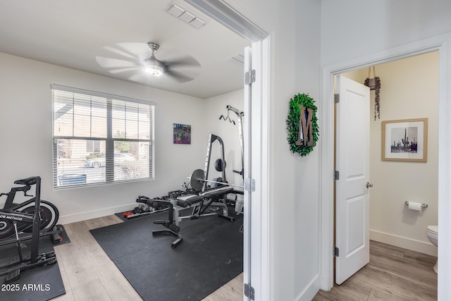 exercise room with light hardwood / wood-style floors and ceiling fan