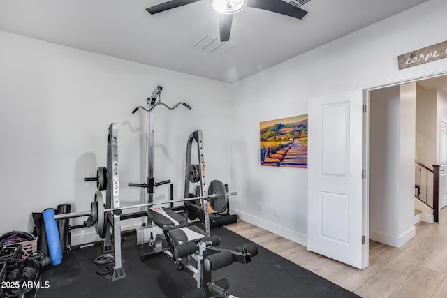 workout room featuring ceiling fan and light hardwood / wood-style flooring