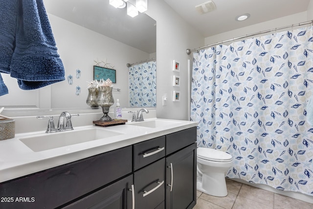 bathroom featuring vanity, toilet, and tile patterned flooring