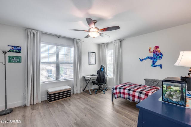 bedroom with light hardwood / wood-style flooring and ceiling fan