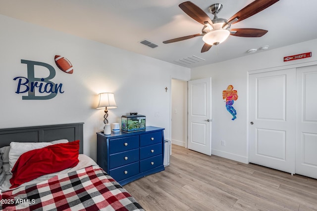 bedroom with light hardwood / wood-style floors, a closet, and ceiling fan