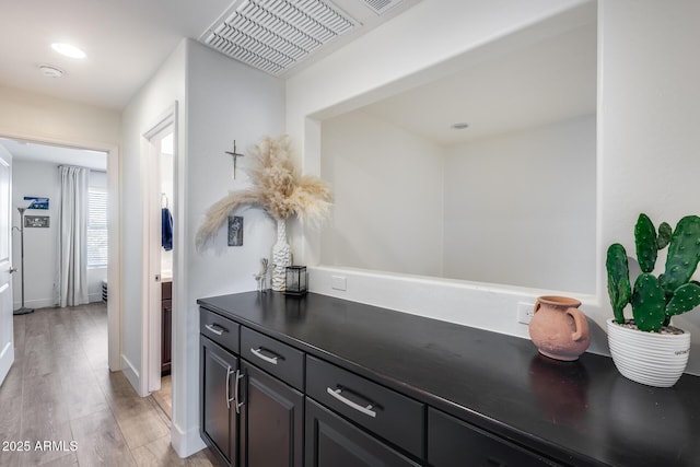 interior space featuring vanity and hardwood / wood-style flooring