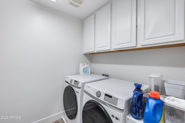 washroom featuring washer and clothes dryer and cabinets