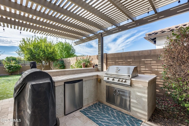 view of patio with a pergola, grilling area, and exterior kitchen