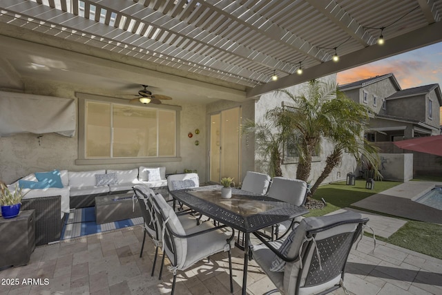 patio terrace at dusk with a pergola, an outdoor hangout area, and ceiling fan