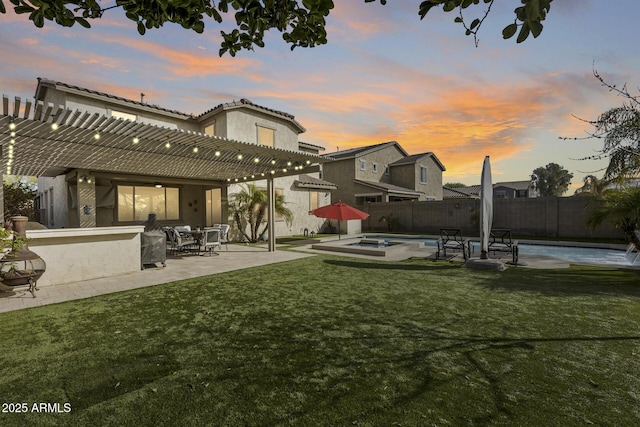 yard at dusk featuring a pool with hot tub, a pergola, and a patio