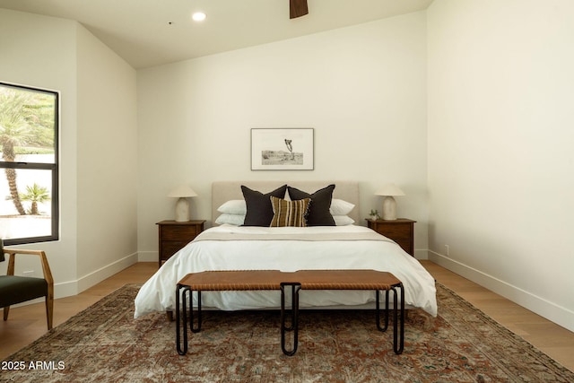 bedroom featuring baseboards, light wood-type flooring, recessed lighting, and vaulted ceiling