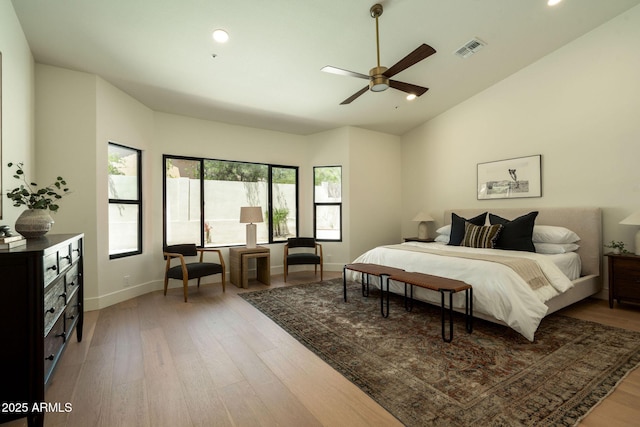 bedroom with recessed lighting, visible vents, lofted ceiling, and light wood-style floors