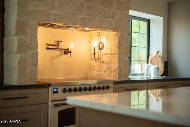 interior details with dark countertops and high end range oven