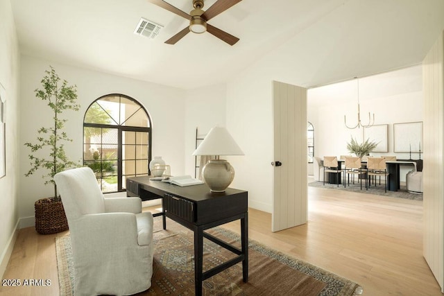 office with baseboards, visible vents, wood finished floors, and ceiling fan with notable chandelier
