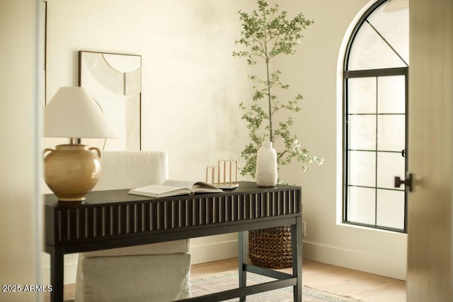 interior space with baseboards and wood finished floors