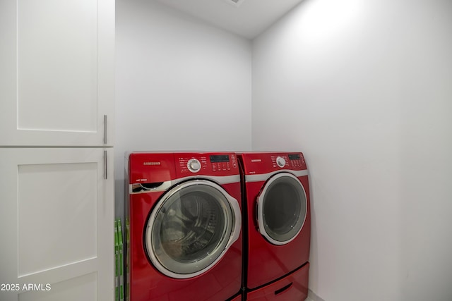 washroom with independent washer and dryer and laundry area