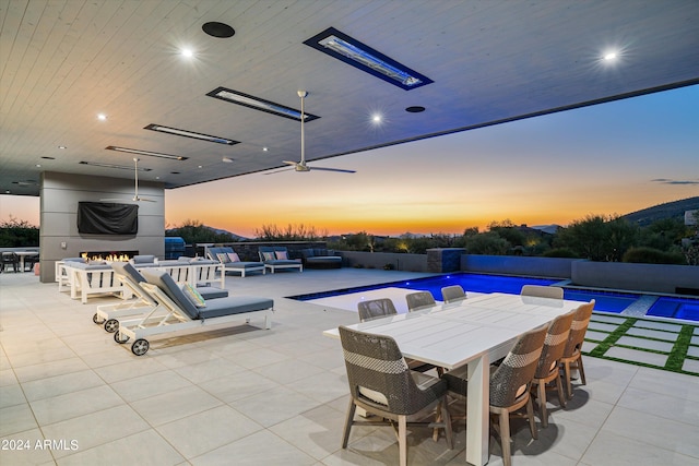 patio terrace at dusk with an outdoor hangout area and ceiling fan