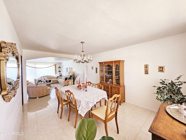2201 E 7th St, Douglas, AZ 85607 - dining room with a chandelier, arched walkways, and light tile patterned floors