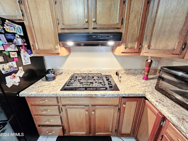 2201 E 7th St, Douglas, AZ 85607 - kitchen with extractor fan, freestanding refrigerator, gas stovetop, and tile patterned floors