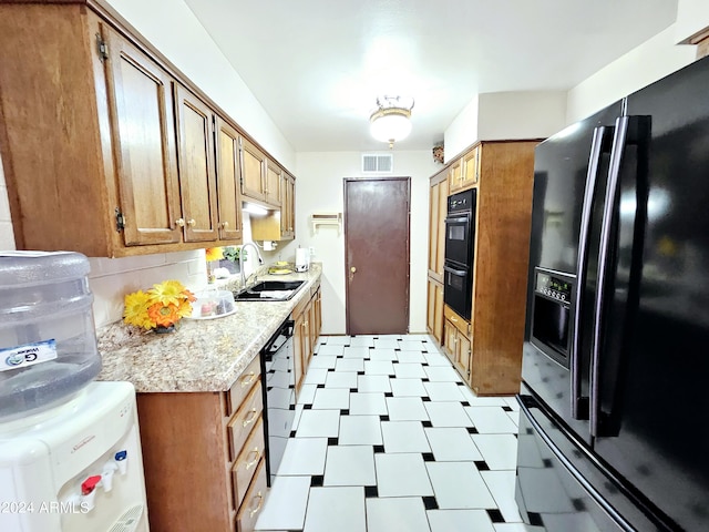 2201 E 7th St, Douglas, AZ 85607 - kitchen with black appliances, brown cabinets, and light countertops