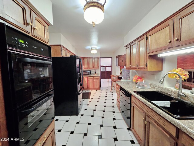 2201 E 7th St, Douglas, AZ 85607 - kitchen with black appliances, light floors, light countertops, and brown cabinetry