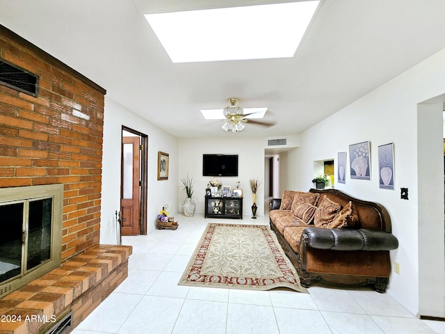 2201 E 7th St, Douglas, AZ 85607 - living room with a skylight, light tile patterned floors, ceiling fan, and a brick fireplace