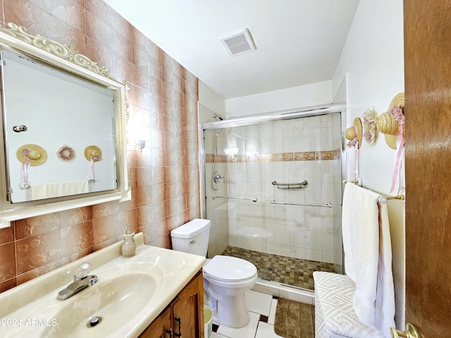 2201 E 7th St, Douglas, AZ 85607 - bathroom with a shower stall, vanity, tile walls, tile patterned flooring, and decorative backsplash
