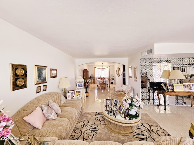 2201 E 7th St, Douglas, AZ 85607 - tiled living room featuring arched walkways and a chandelier