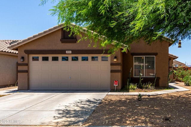 6515 W Hughes Dr, Phoenix, AZ 85043 - view of front of home with a garage, driveway, and stucco siding