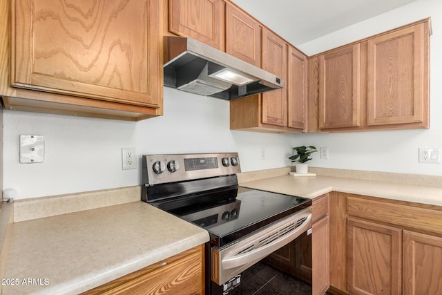 6515 W Hughes Dr, Phoenix, AZ 85043 - kitchen with stainless steel range with electric stovetop, under cabinet range hood, light countertops, and brown cabinetry