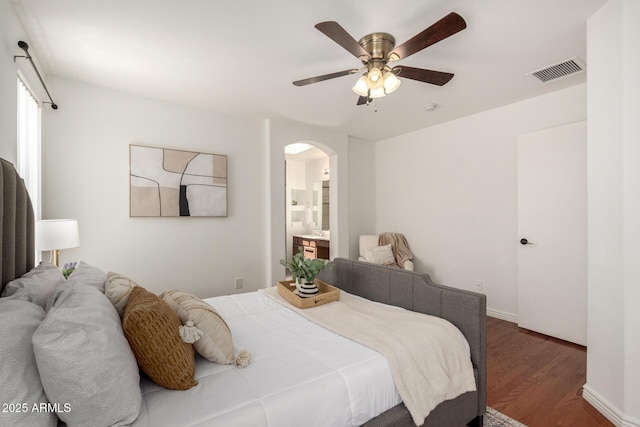 6515 W Hughes Dr, Phoenix, AZ 85043 - bedroom with arched walkways, wood finished floors, ceiling fan, and ensuite bathroom