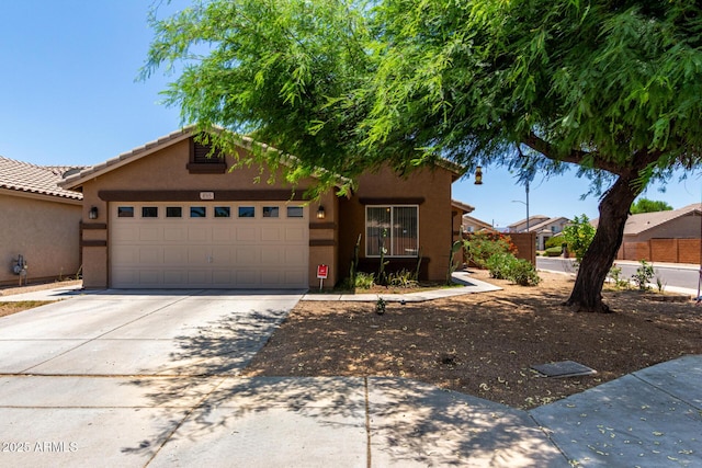 6515 W Hughes Dr, Phoenix, AZ 85043 - view of front of property with driveway, a garage, and stucco siding