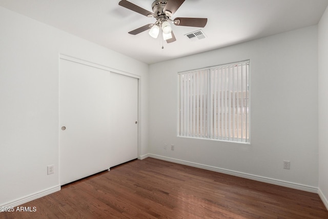 6515 W Hughes Dr, Phoenix, AZ 85043 - unfurnished bedroom featuring wood finished floors, a closet, and a ceiling fan