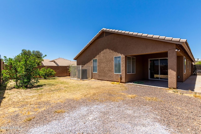 6515 W Hughes Dr, Phoenix, AZ 85043 - back of house with a fenced backyard, stucco siding, and a patio area