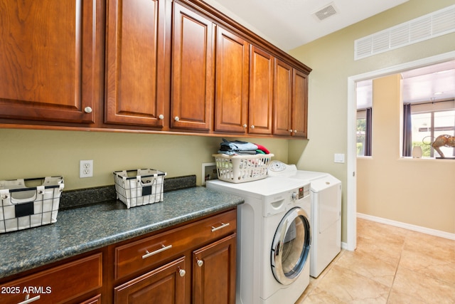 laundry area featuring visible vents, washer and dryer, baseboards, cabinet space, and light tile patterned floors