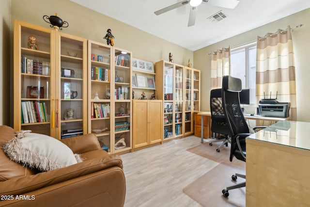 office area with visible vents, light wood-style floors, and ceiling fan