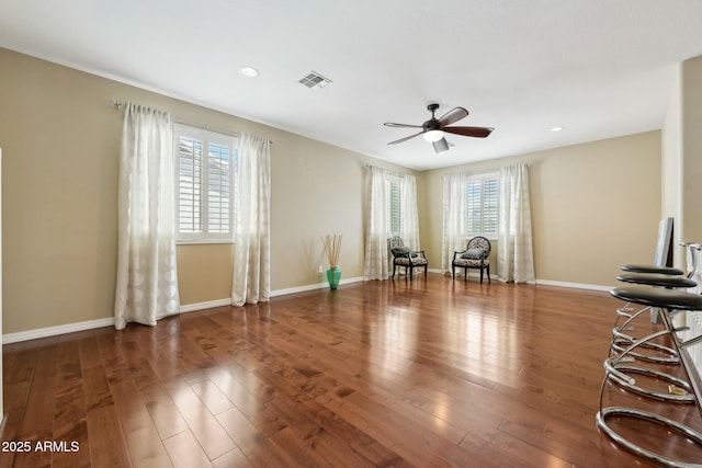 interior space featuring visible vents, wood finished floors, baseboards, recessed lighting, and a ceiling fan