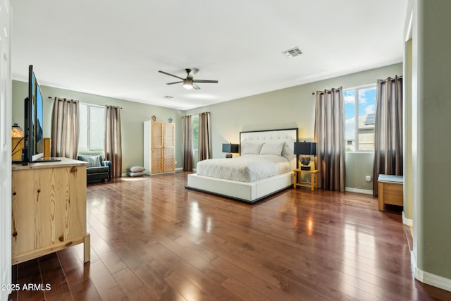 bedroom with baseboards, ceiling fan, dark wood-style flooring, and visible vents