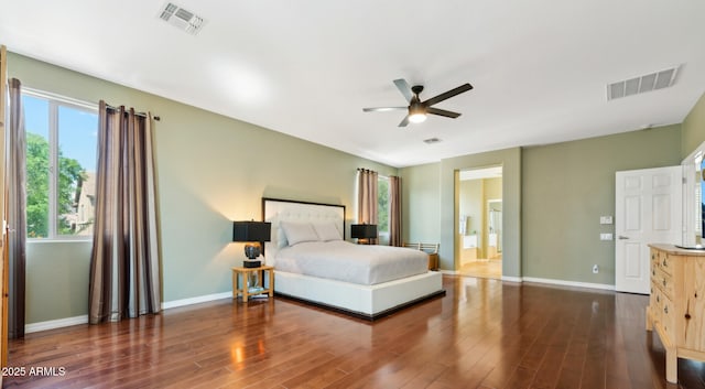 bedroom featuring baseboards, visible vents, and wood finished floors