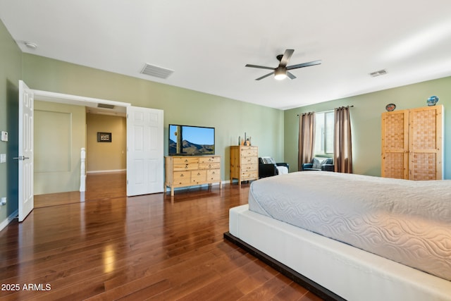 bedroom with visible vents, baseboards, and wood finished floors