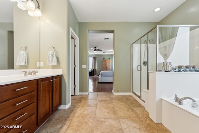 ensuite bathroom featuring a ceiling fan, a bath, a stall shower, vanity, and ensuite bath