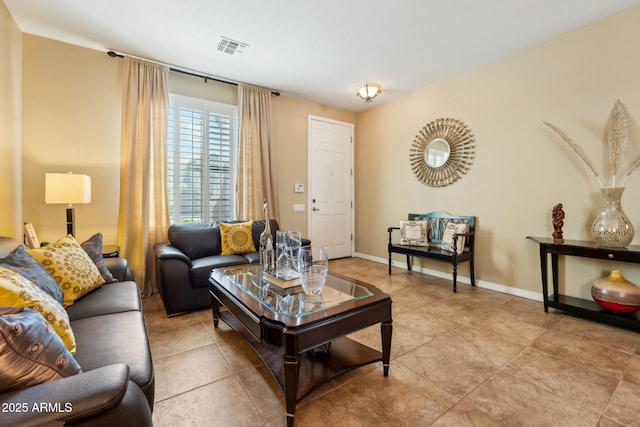 living area featuring light tile patterned floors, baseboards, and visible vents