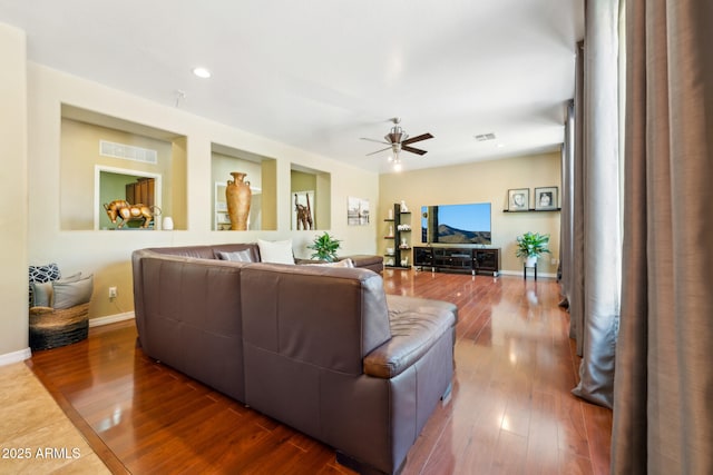 living room with a ceiling fan, visible vents, wood finished floors, baseboards, and recessed lighting