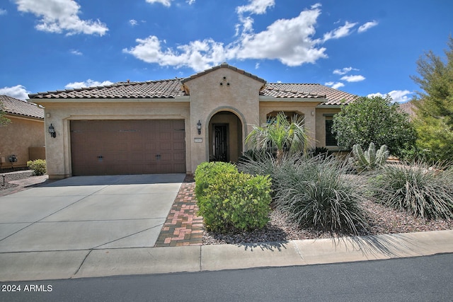 mediterranean / spanish house featuring a garage