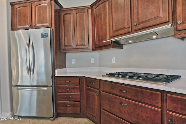 kitchen featuring stainless steel appliances and light tile floors