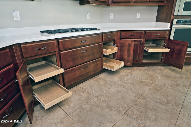 kitchen featuring appliances with stainless steel finishes and light tile floors